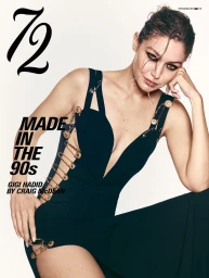 Model Gigi Hadid posing in a black safety pin gown against a white studio background for 72 Magazine.