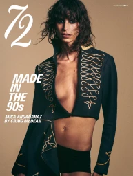 Mica Argañaraz wearing an open black embroidered military jacket against a beige background for 72 Magazine.