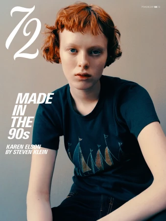 Model Karen Elson with short red hair wearing a dark graphic t-shirt against a neutral studio backdrop on a magazine cover.