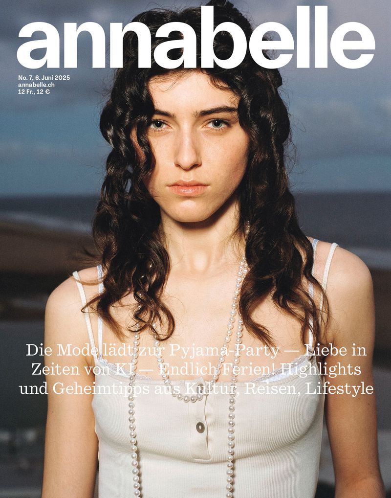 Annabelle magazine cover featuring a female model with long, dark curly hair, wearing a white top and pearl necklace, against a beach backdrop.
