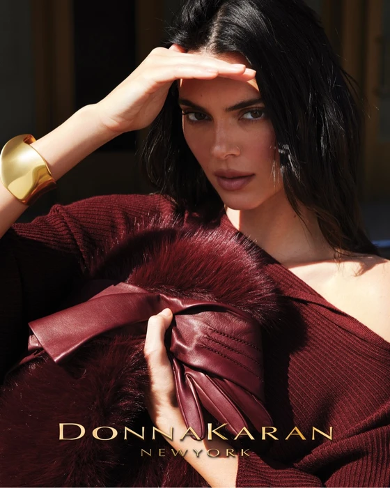 Kendall Jenner wearing a burgundy ribbed knit top and gold cuff bracelet for the Donna Karan Fall 2026 campaign.