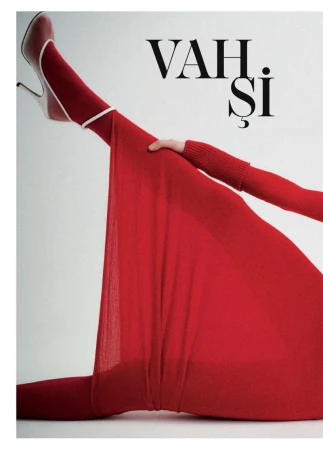 Model Patrycja Piekarska poses with leg raised wearing a vibrant red knitted dress and white-trimmed heels against a white backdrop.