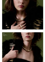 Model wearing a gold textured collar necklace, matching ring, and black faux fur trim against an olive green backdrop.