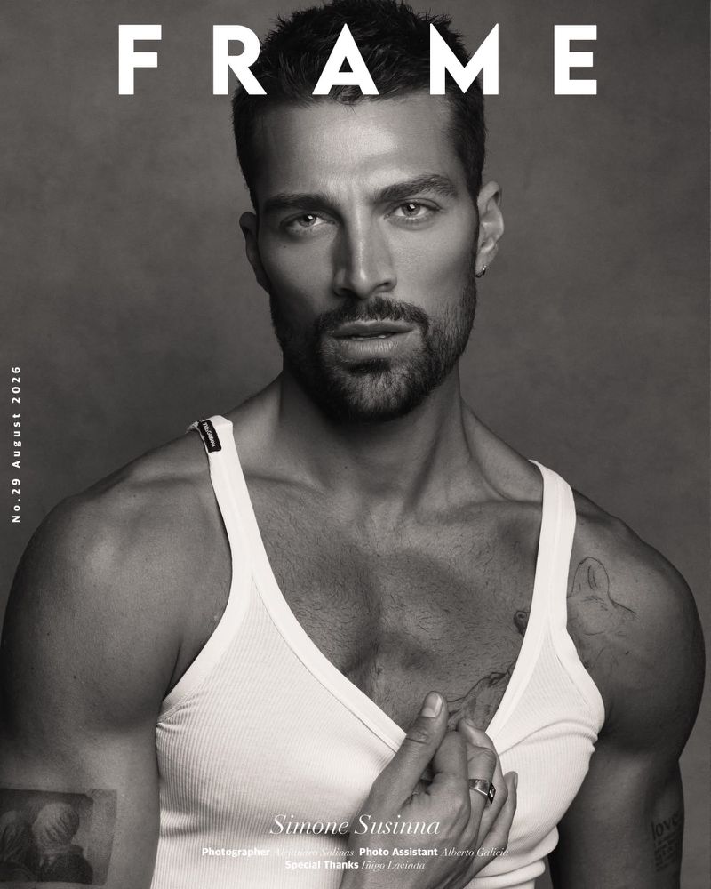 Monochrome portrait of Simone Susinna wearing a white tank top looking at the camera on a magazine cover layout.