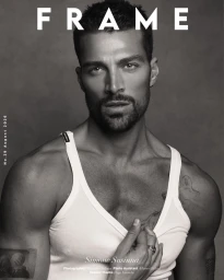 Monochrome portrait of Simone Susinna wearing a white tank top looking at the camera on a magazine cover layout.