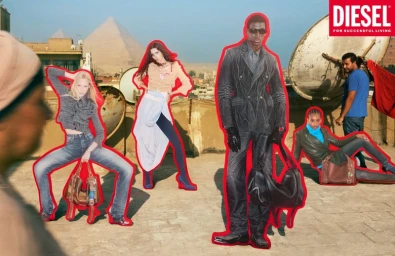 Diesel campaign cutouts with red outlines displayed on a rooftop overlooking the Giza pyramids.