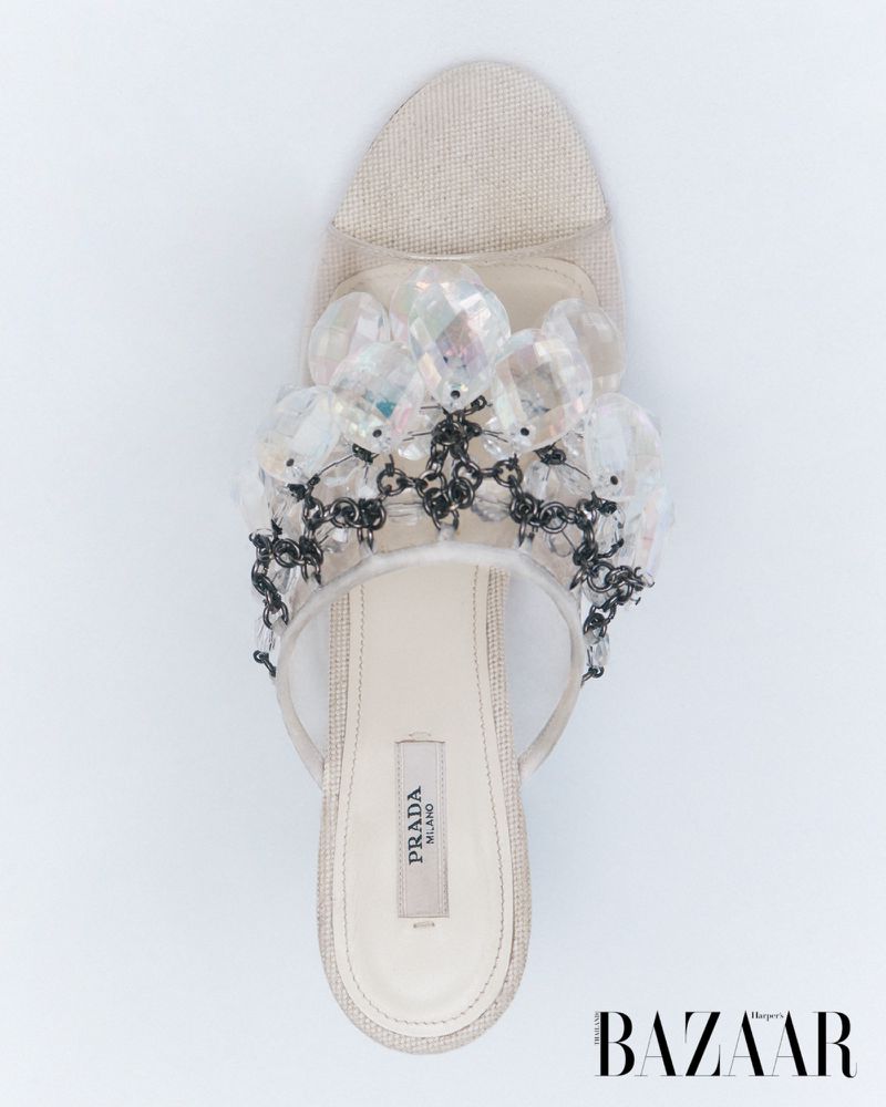 Beige PRADA heeled sandal with beaded embellishments on a white backdrop, showcasing luxury women's fashion footwear.