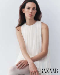 Model Ruby Aldridge in a white sleeveless dress against a plain white studio background for Harper's Bazaar Thailand