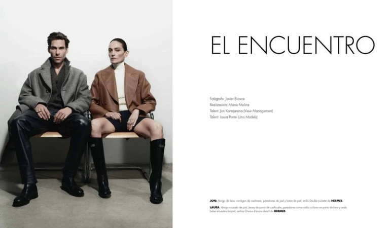 Jon Kortajarena and Laura Ponte seated side by side in tailored coats and boots for an El Encuentro fashion editorial layout.