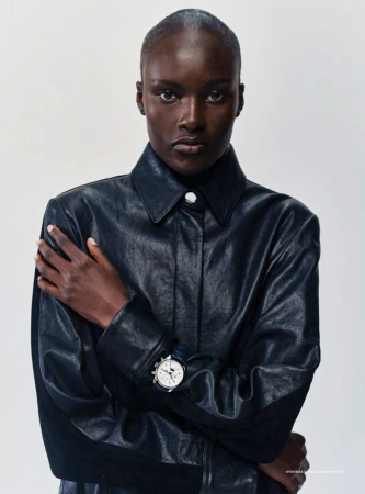 Model Amou Ring posing in a black leather buttoned jacket and wristwatch against a plain studio background.