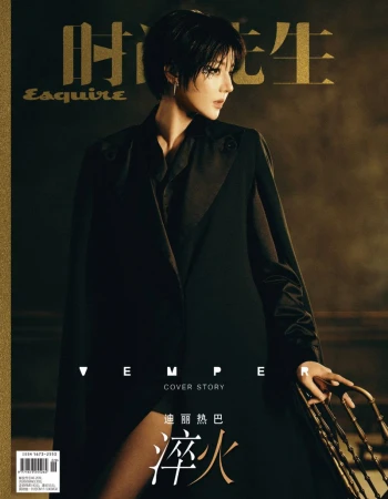 Dilraba Dilmurat with short dark hair wearing a black cape coat and holding an ornate metal chair on the cover of Esquire China.