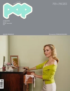 Gillian Anderson posing beside a wooden dresser with an open drawer on the cover of Pop Magazine.