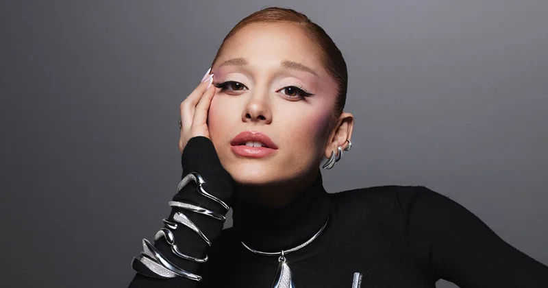 Ariana Grande wearing silver crystal jewellery and black turtleneck against grey background for Swarovski