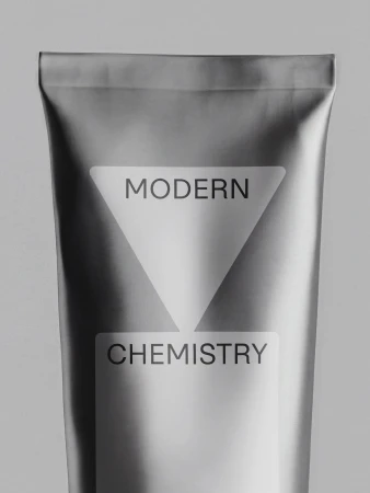 Close-up of a matte metallic grey squeeze tube packaging printed with Modern Chemistry branding against a solid light grey background.