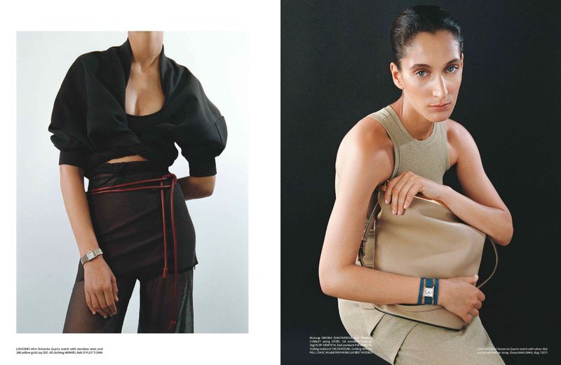 Two fashion models pose in front of a white and black background, wearing high-fashion attire and watches for a magazine spread.