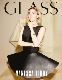 Vanessa Kirby wearing a black dress in front of a neutral textured backdrop for Glass Magazine.