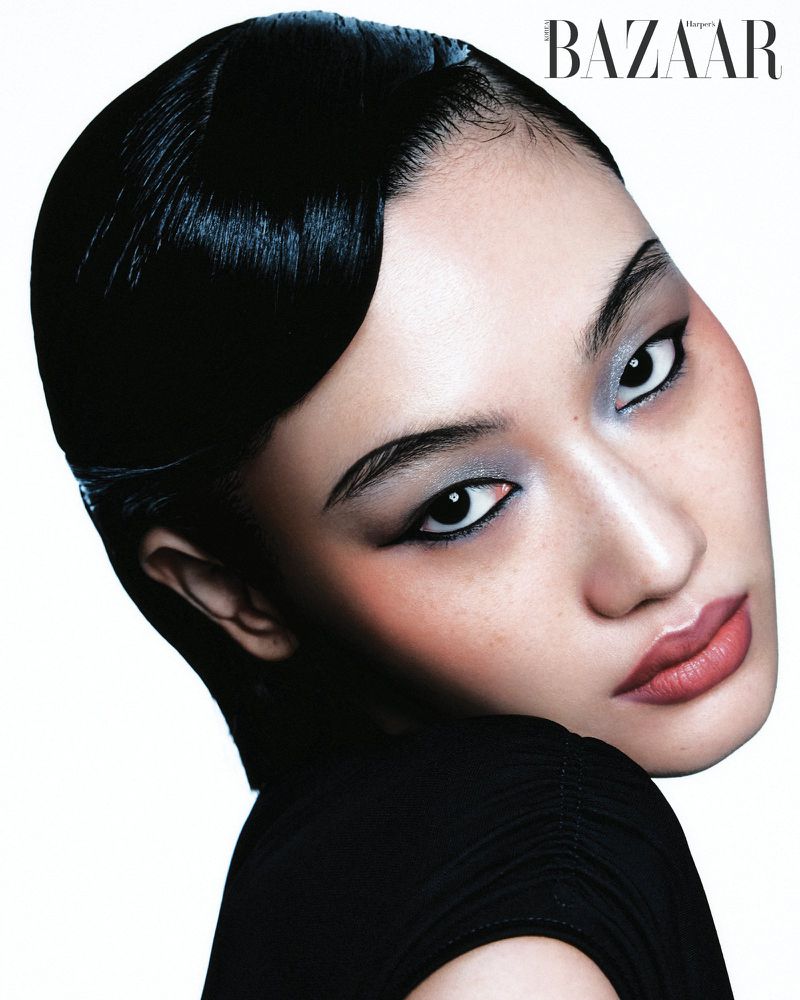 Close-up beauty portrait of model Yuemeng Ma with sleek finger-wave hair and silver eyeshadow against a white seamless background.