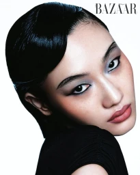 Close-up beauty portrait of model Yuemeng Ma with sleek finger-wave hair and silver eyeshadow against a white seamless background.