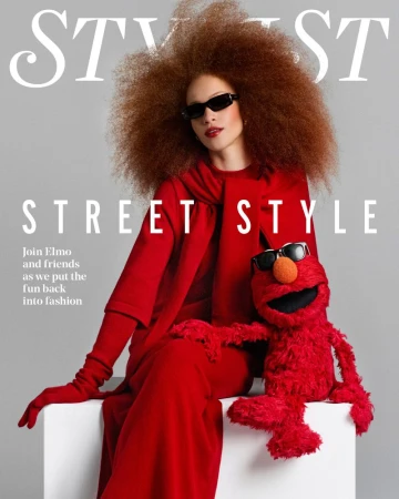 Model Tianna St. Louis and Elmo pose in matching sunglasses and vibrant red outfits on the Stylist Magazine UK cover.