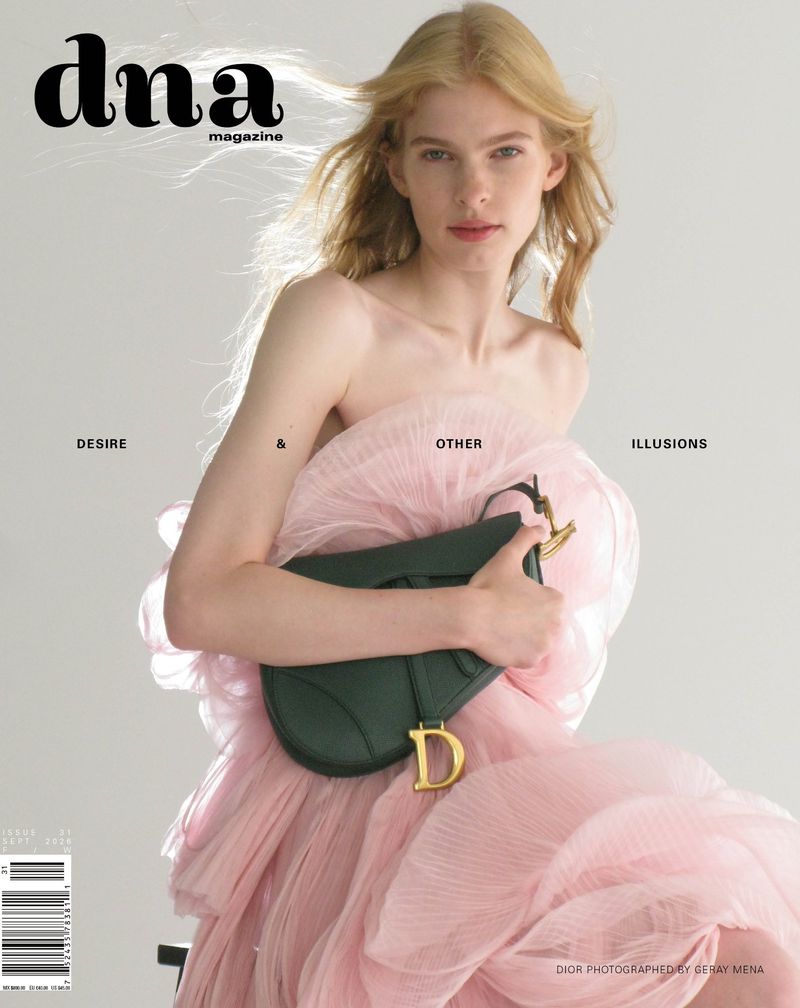 Model Victoria Volt in a ruffled pink tulle dress holding a dark green leather saddle bag on the cover of DNA Magazine.