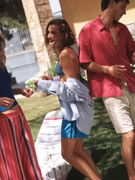 Three models outdoors in casual summer apparel with sunlight filtering through an outdoor space for Mavi SS '25 Maviterranean campaign.
