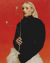 Chloe Kelly holding slender green stems against a vibrant red backdrop in editorial portrait