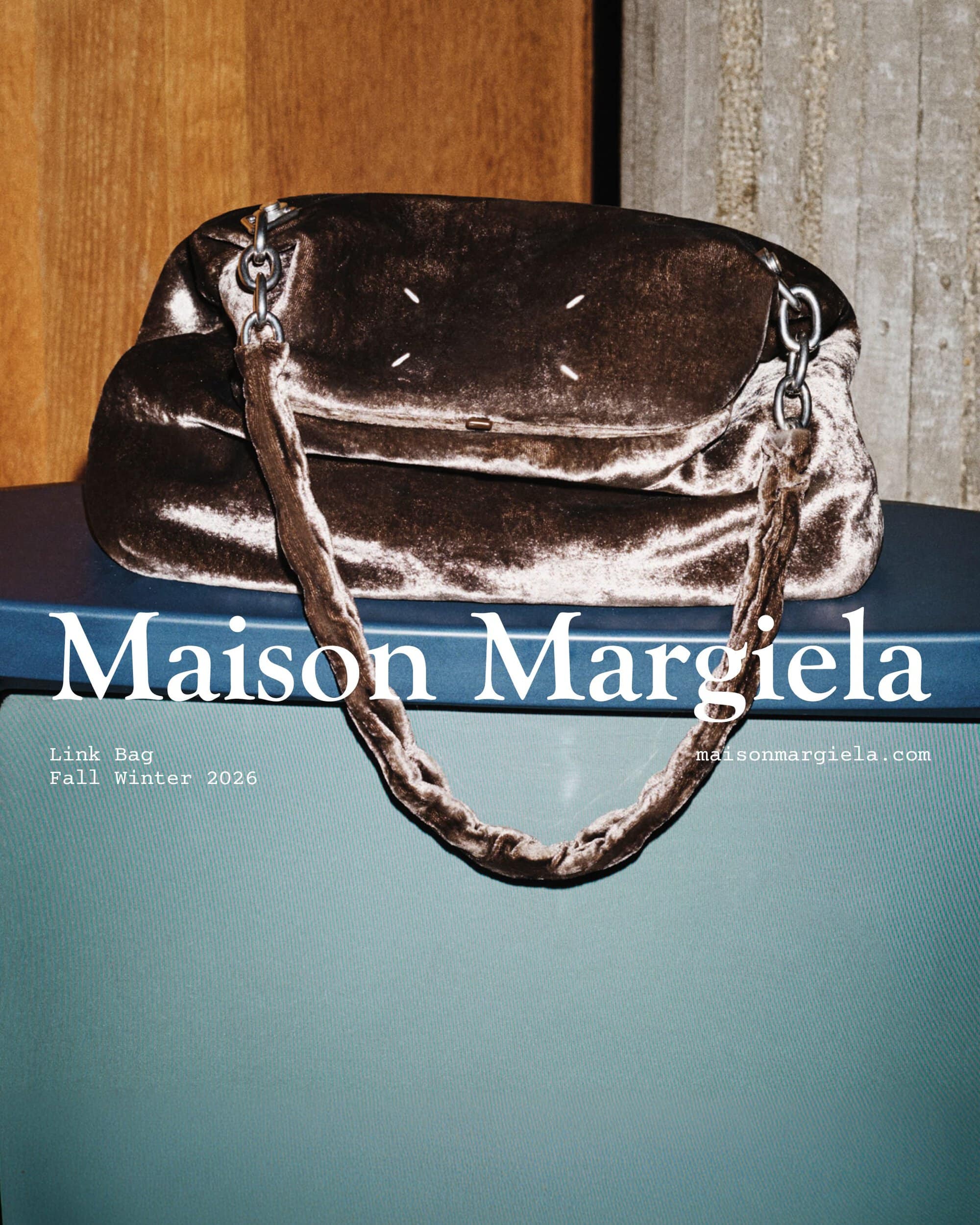 Maison Margiela crushed brown velvet Link Bag with a chain strap resting on a monitor.