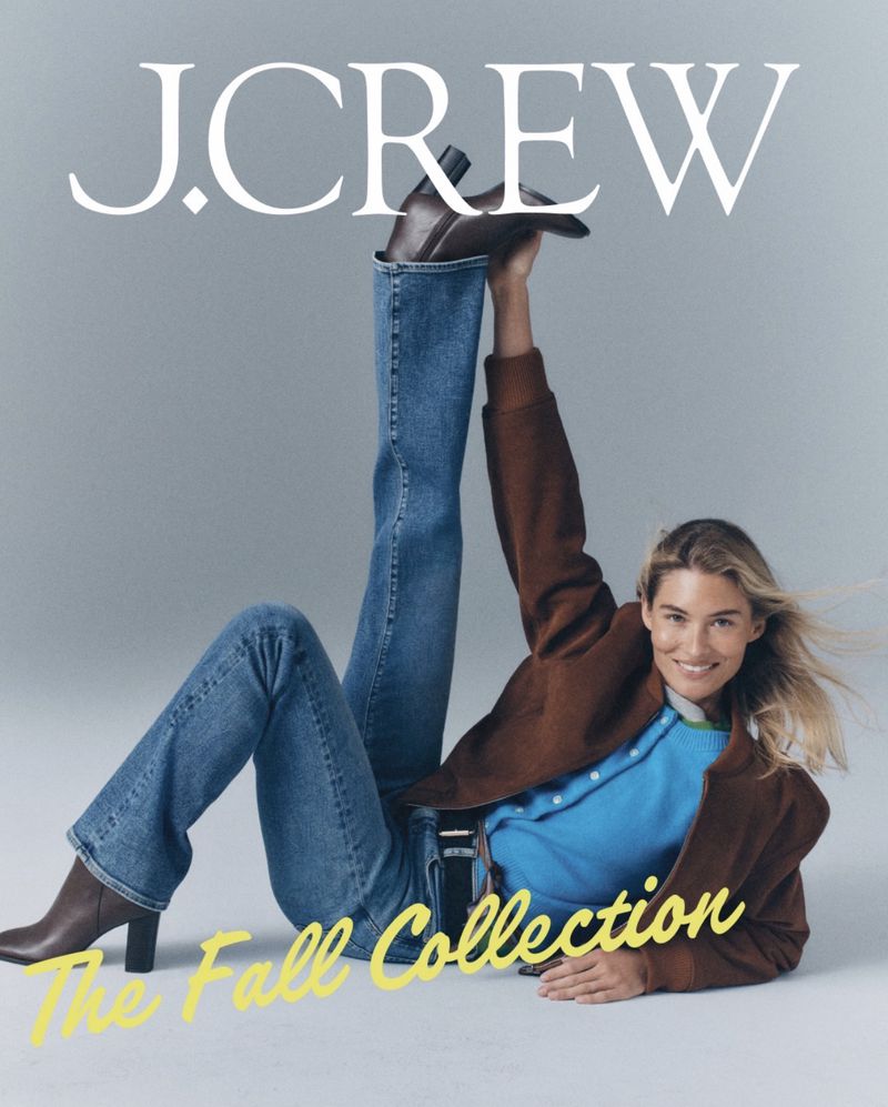 Model Grace Elizabeth lying on a studio floor with one leg raised in blue denim jeans and brown leather boots for J. Crew.