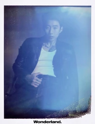 Jay Park posing in an open black jacket and white tank top in a polaroid-style portrait for Wonderland China.