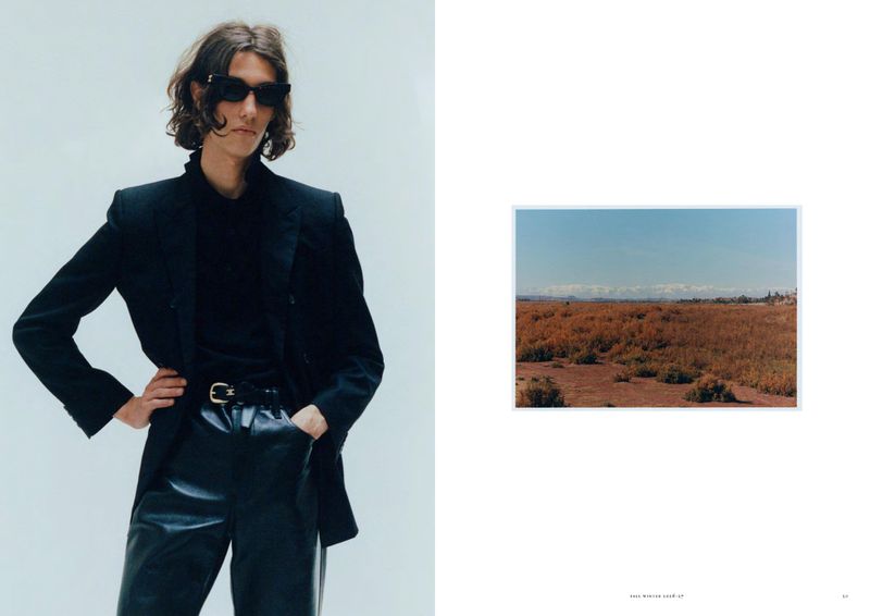 Fashion model wearing black sunglasses, a tailored black blazer, and black leather trousers on a magazine editorial spread.