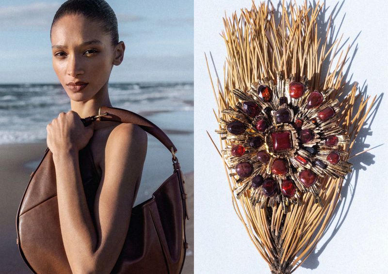 Model Elodie Guipaud holding a brown leather shoulder bag on a beach beside a jeweled brooch on pine needles.