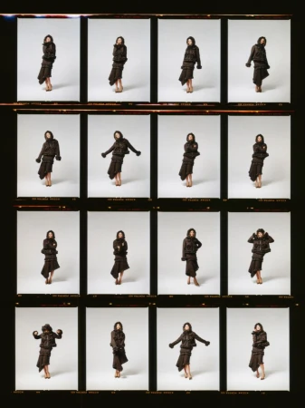 A film contact sheet featuring sixteen individual frames of Jodie Comer posing in a dark layered outfit against a studio backdrop.