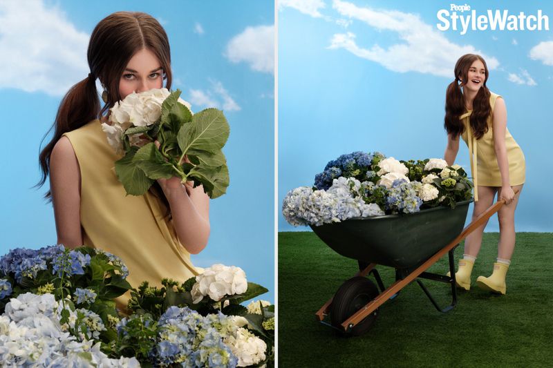 Diptych of Harlow Jane in a yellow mini dress posing with white and blue hydrangeas and a wheelbarrow against a painted sky backdrop.