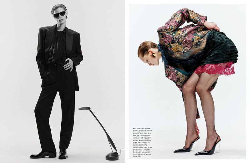 Editorial fashion shoot: A slim adult in a black suit stands near a lamp; another adult bends in a patterned jacket.