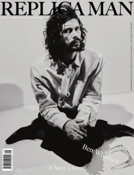 Actor Ben Whishaw seated on the floor wearing a collared shirt, tie, and dark trousers for Replica Man Magazine cover.