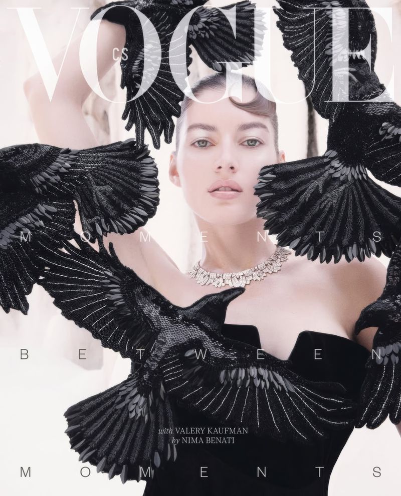 Vogue cover featuring a fashion model wearing a black strapless dress and a diamond necklace, adorned with black bird-shaped embellishments.