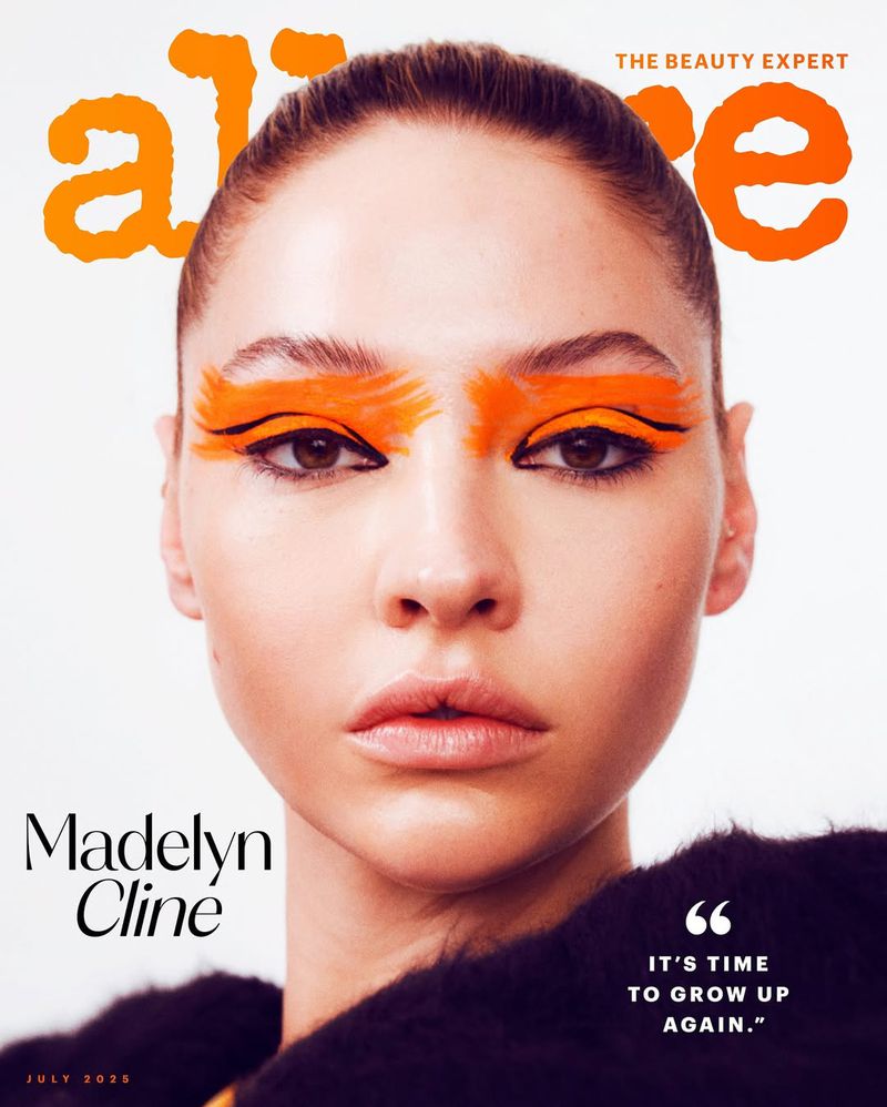Close-up magazine cover featuring Madelyn Cline with orange eyeshadow and black eyeliner. The magazine's name, Alive, is in orange font.
