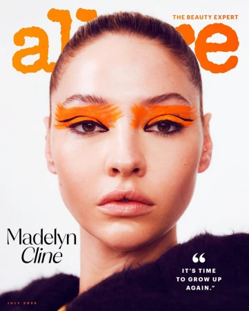 Close-up magazine cover featuring Madelyn Cline with orange eyeshadow and black eyeliner. The magazine's name, Alive, is in orange font.