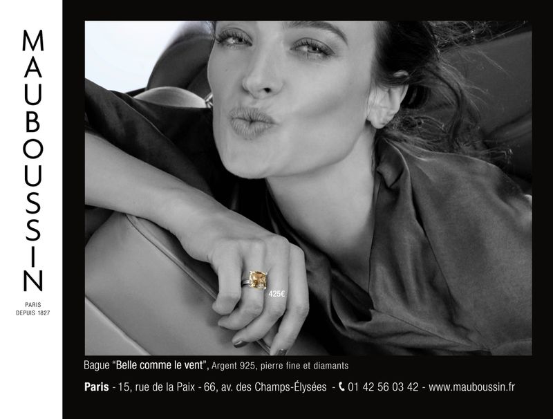 Close-up of a woman wearing a diamond ring, featured in a Mauboussin advertisement, promoting jewelry with an elegant, monochrome aesthetic.