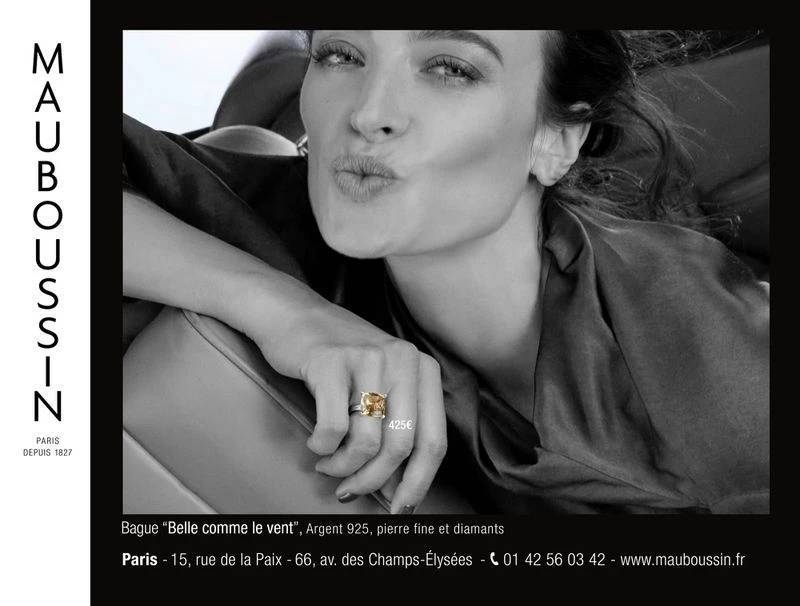 Close-up of a woman wearing a diamond ring, featured in a Mauboussin advertisement, promoting jewelry with an elegant, monochrome aesthetic.