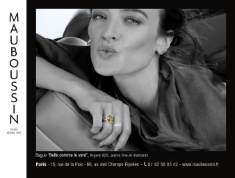 Close-up of a woman leaning on a car seat wearing a large gemstone ring for Mauboussin campaign