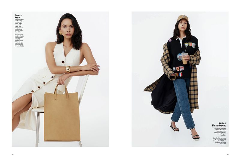 Editorial fashion shoot of two adult women in a photo studio. One is sitting with a paper bag, another is holding a coffee cup.