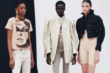 Three models wearing designer fashion collections pose against a split white and black studio backdrop.