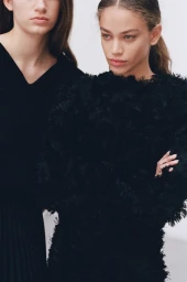 Two female models in black textured clothing posing against a plain white background for Beyond Noise