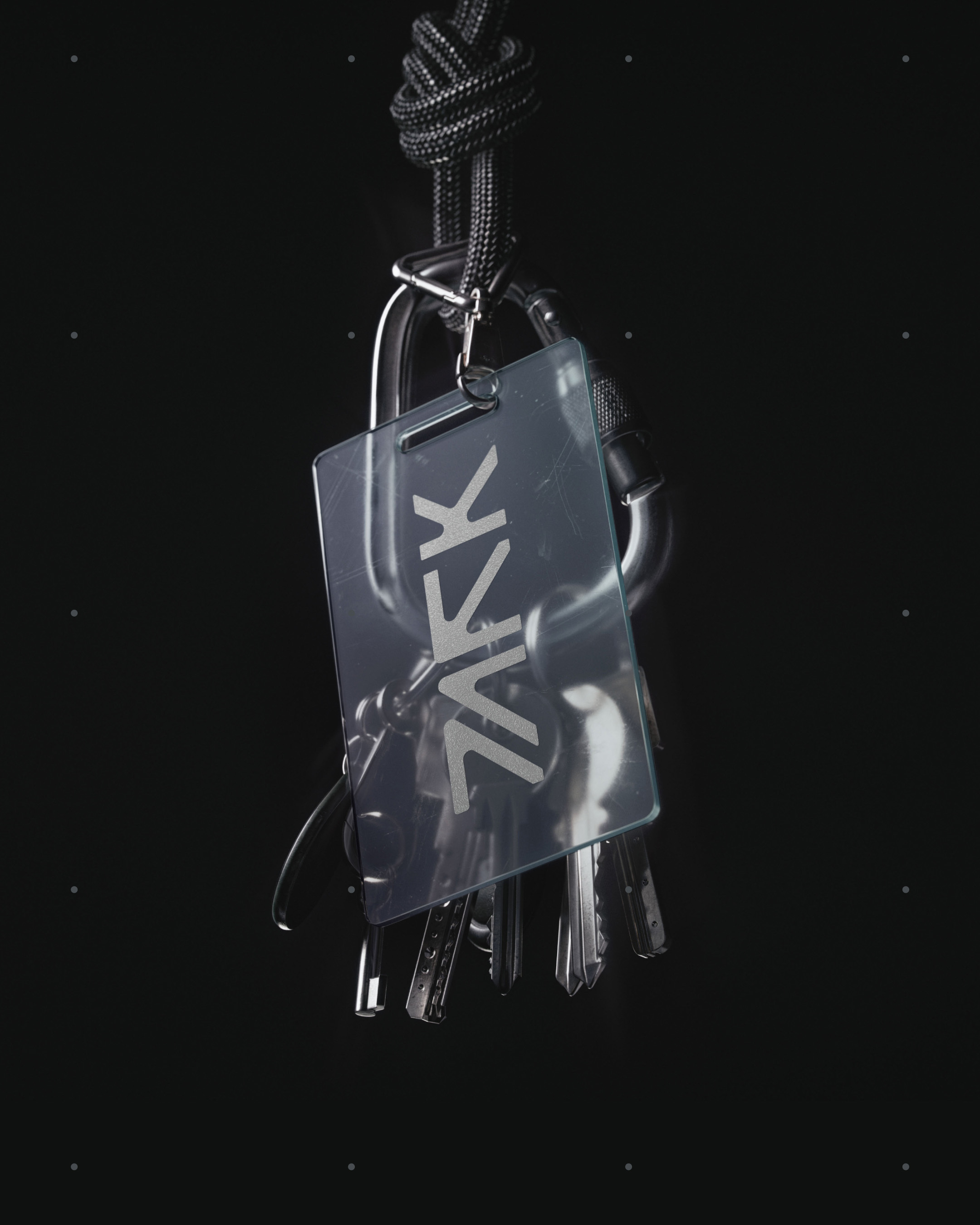 Transparent ID badge with branded typography hanging from metal carabiners and a black cord on a dark background