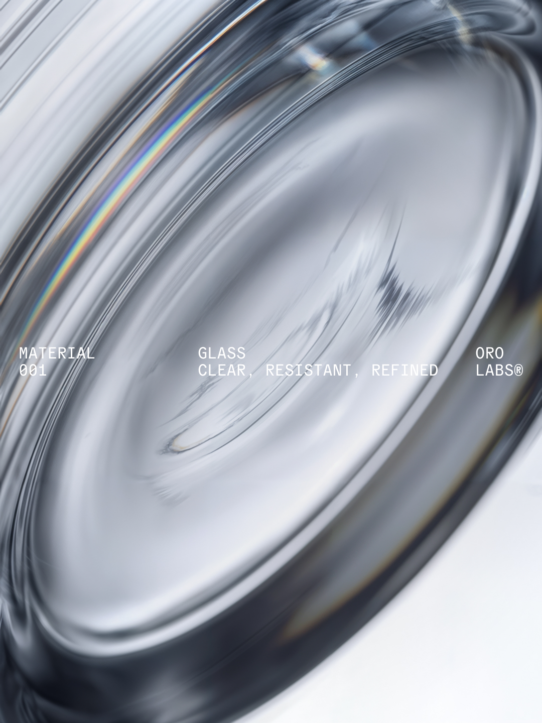 Extreme close-up macro view of thick curved glass surface with subtle prismatic light refractions and clean typography layout.
