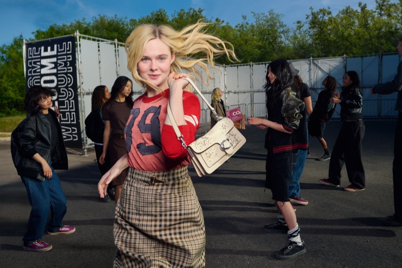 Elle Fanning holding a cream shoulder bag in a campaign shot by Elaine Constantine for Coach Live Your Story.