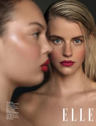 Close-up beauty portrait of two women, one in profile with red lips and one facing forward with freckles and magenta lipstick.