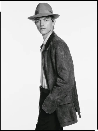 Man wearing a fedora hat and suede jacket against a plain white studio background for the Borsalino campaign