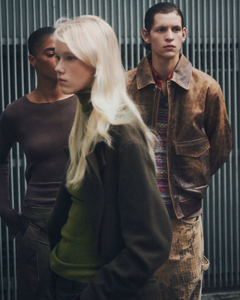 Three models wearing autumn apparel posing against a vertical metal slatted background for Zara Pre-owned
